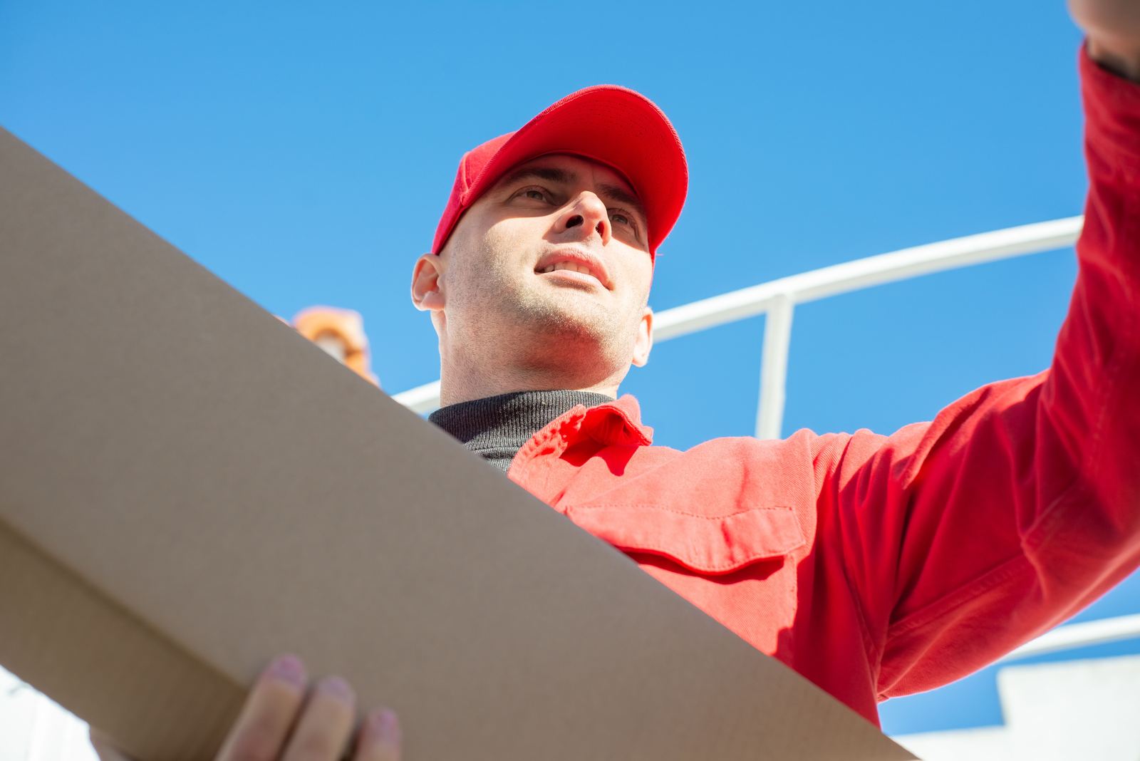 Courier carrying a package for last-mile delivery